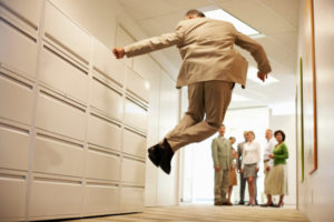 leaping-bizman Senior Businessman Jumping in Corridor